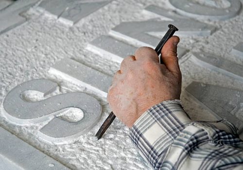 marble worker is making a tombstone.